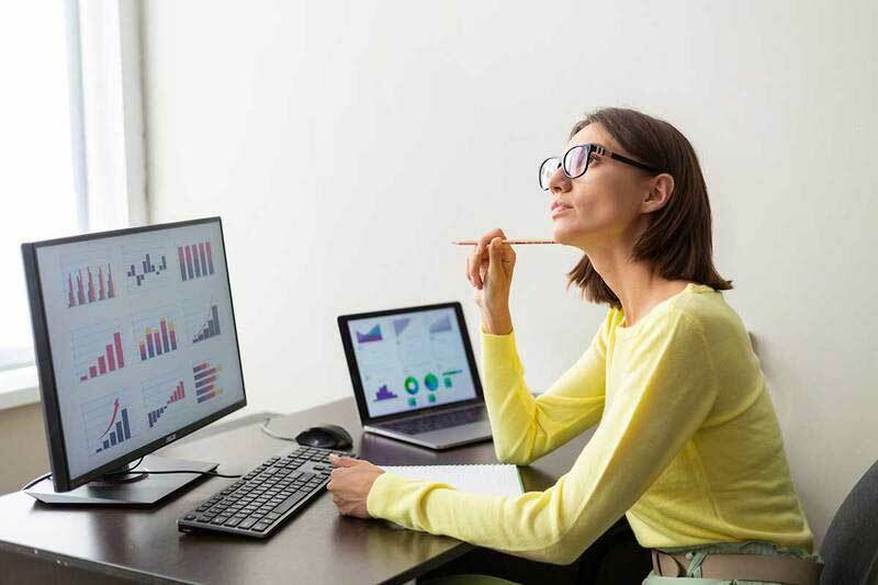 Woman thinking while on her computer