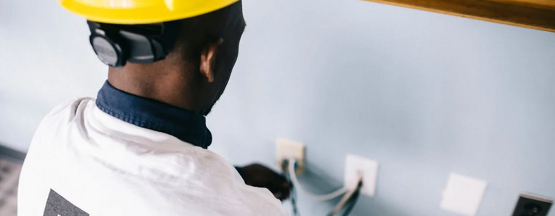 Electrician working on a circuit breaker