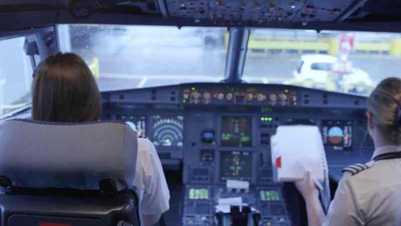 two pilots in the cockpit of a plane